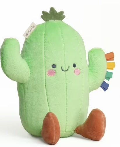 Plush cactus toy with a smiling face on a white background