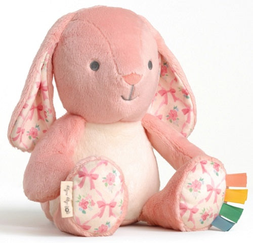 Pink plush bunny with floral patterns on ears and feet.