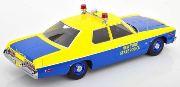A 1/18 scale model of a 1974 Dodge Monaco NY State Police car in yellow and blue colors with red lights on roof.