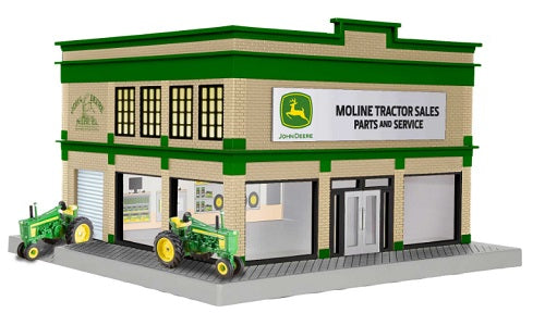 Model of John Deere tractor sales & service building with 2 tractors sitting outside.