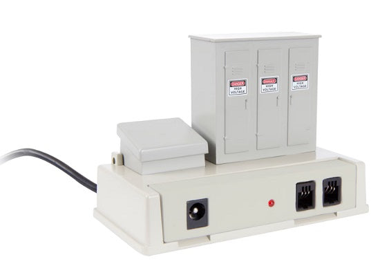 A gray toy train infrared controller with multiple connectors.