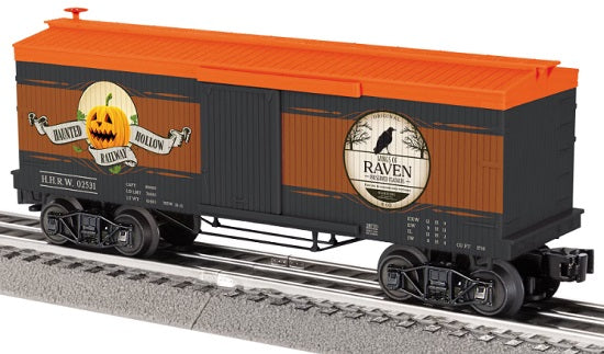 Halloween themed box car on railroad track.