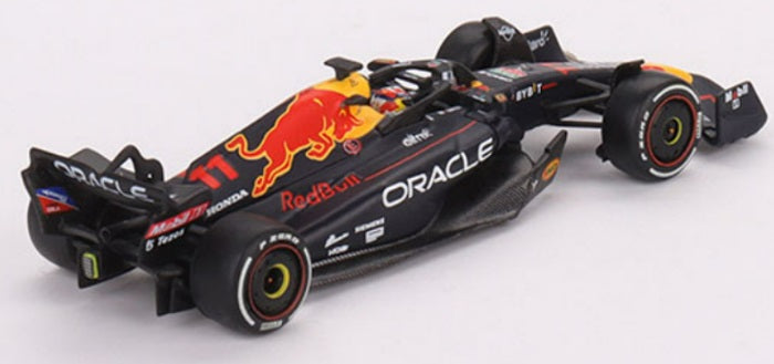 A 1/64 scale model of a Red Bull Oracle Racing Formula 1 car in black, yellow, and red colors.