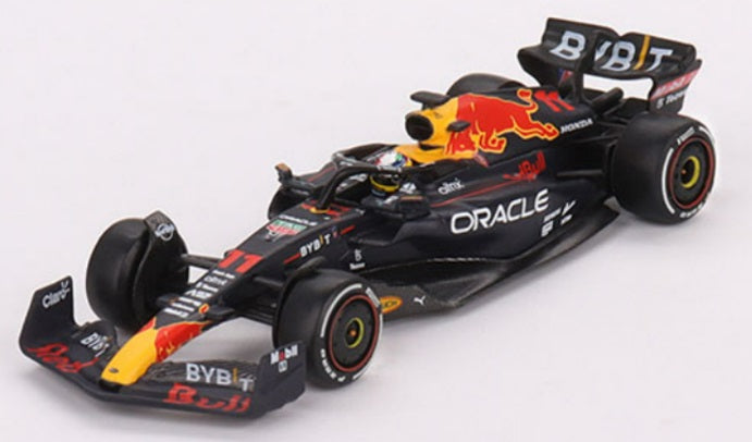 A 1/64 scale model of a Red Bull Oracle Racing Formula 1 car in black, yellow, and red colors.