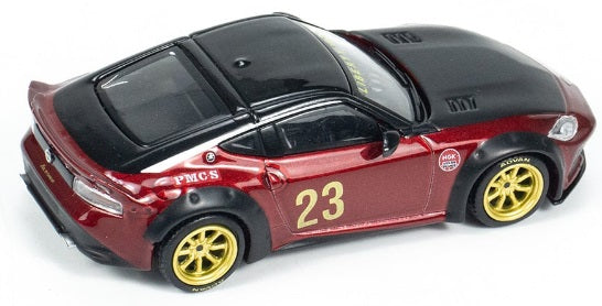 A 1/64 scale model of a red Nissan Z LB Nation Works Gem with black details and gold wheels.