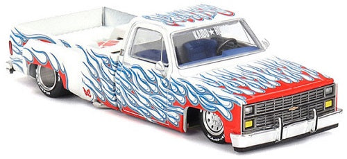 1/64 scale model of white Chevy Silverado with lowered chassis and red and blue flames.