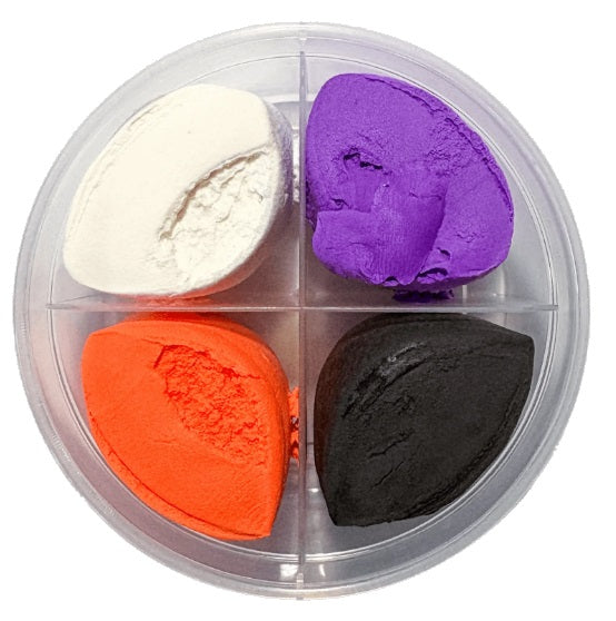 Plastic container divided into 4 sections with white, purple, orange, and black clay.