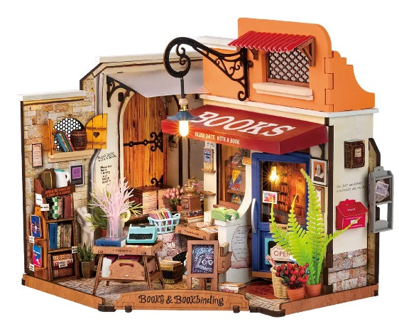 Assembled Corner Bookstore kit, with books inside and outside the store and working lights.