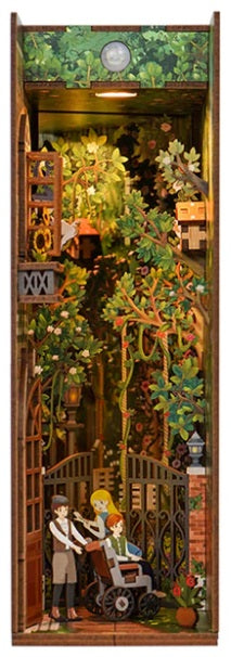 Assembled Secret Garden Book Nook kit, featuring small figures entering through a garden gate.
