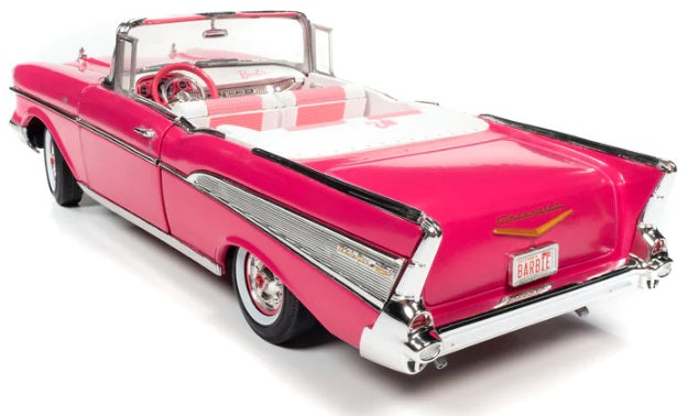 A 1/18 scale model of a 1957 Chevrolet Bel Air Convertible in pink color with open convertible roof.