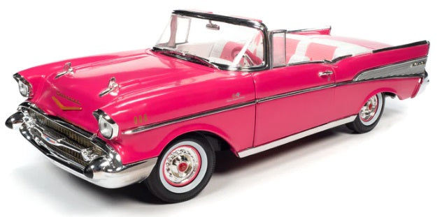 A 1/18 scale model of a 1957 Chevrolet Bel Air Convertible in pink color with open convertible roof.