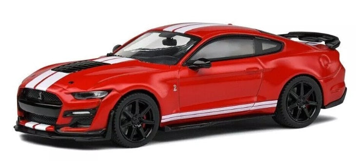 A 1/43 scale model of a red 2020 Ford Shelby Mustang GT500 with black rims and white stripes.