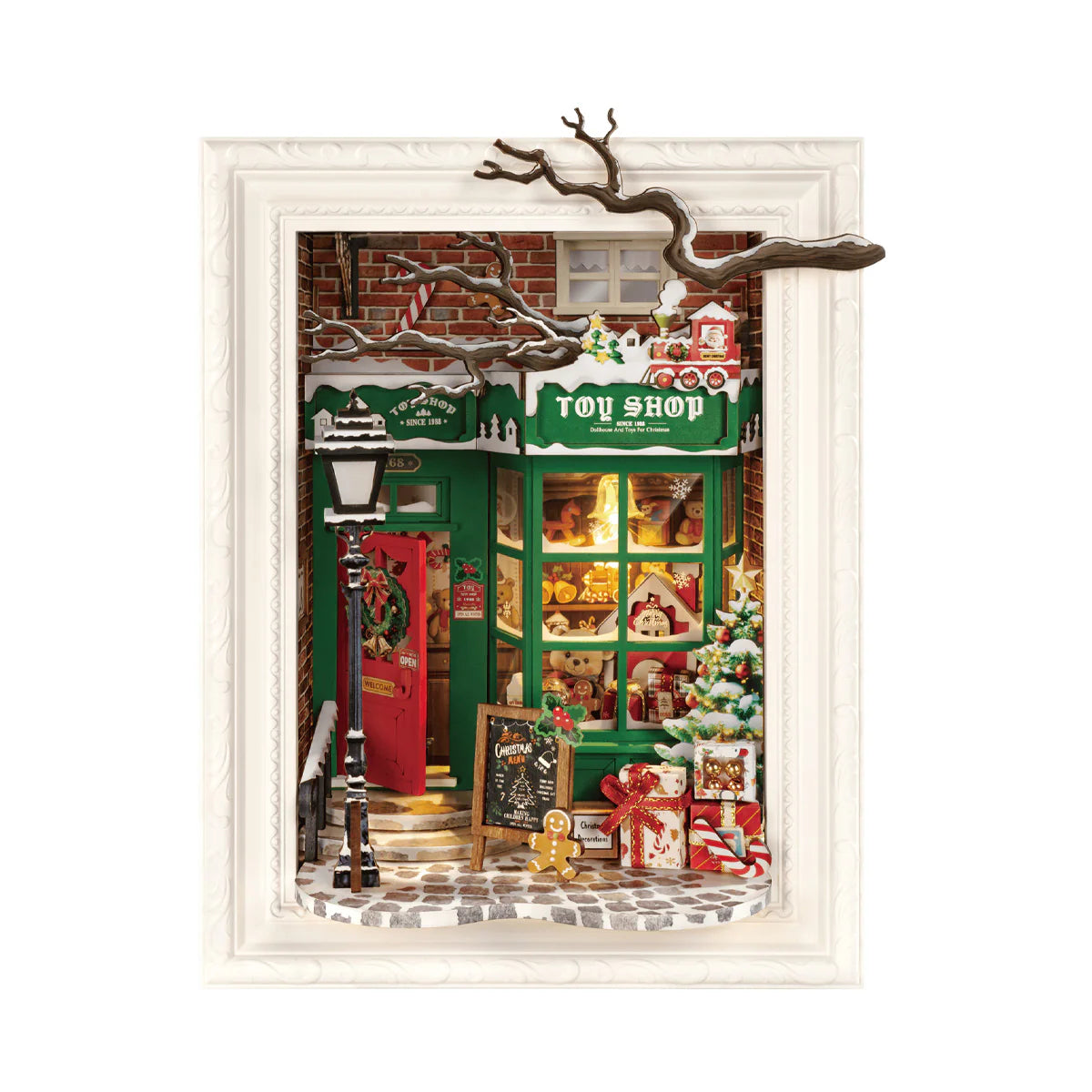 Miniature toy shop scene with Christmas decorations inside a framed picture.