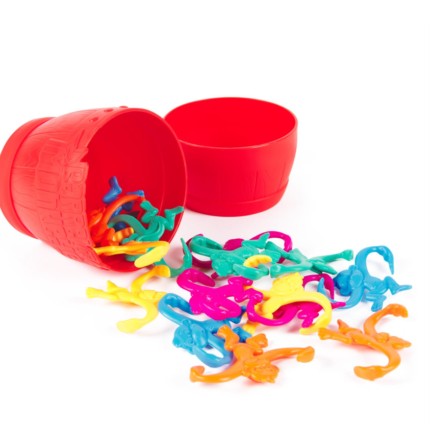 Colorful barrel with monkey shaped pieces spilled out in front.