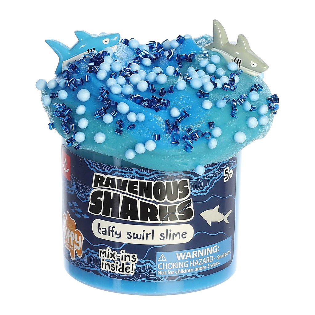 A jar of blue slime with taffy swirls and shark-themed mix-ins, labeled as 'Ravenous Sharks' from Poppy Slime Co.