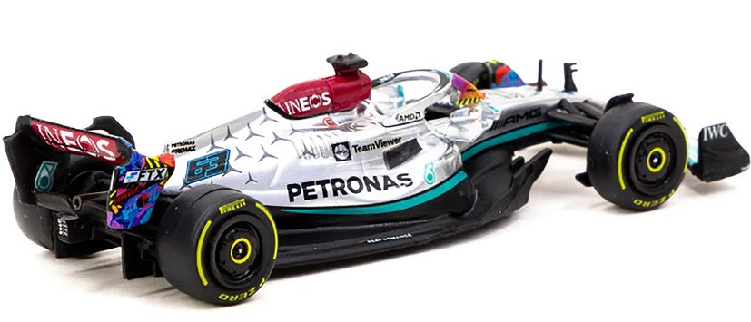 1/64 scale diecast model of a Mercedes AMG Formula 1 car black, silver and turquoise in color.