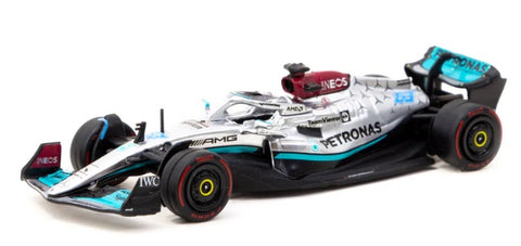 1/64 scale diecast model of a Mercedes AMG Formula 1 car black, silver and turquoise in color.