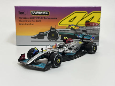 1/64 scale model of a Mercedes-AMG F1 Racer in black, turquoise and silver with box picturing the same car behind it.