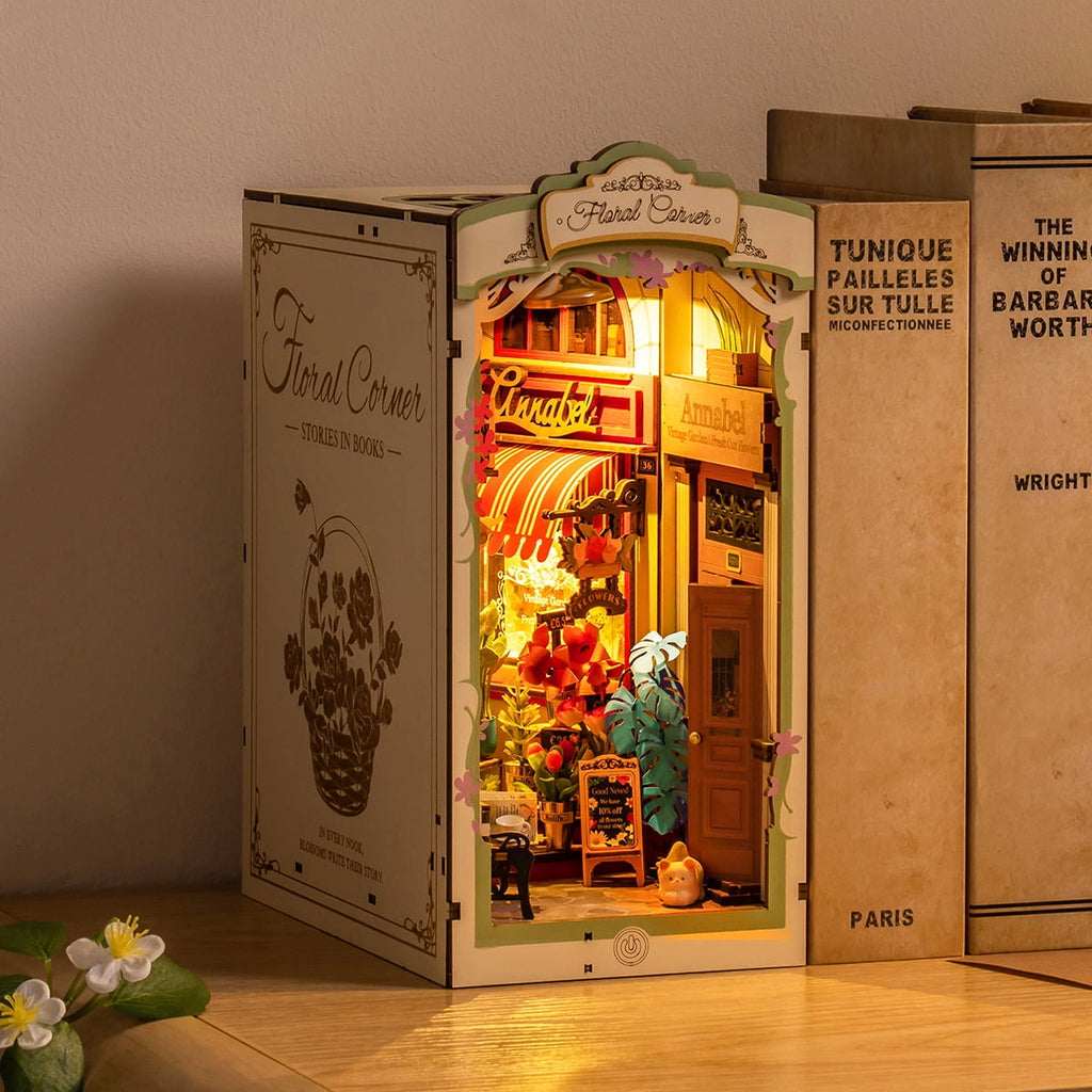 Miniature book nook display with lighted interior,