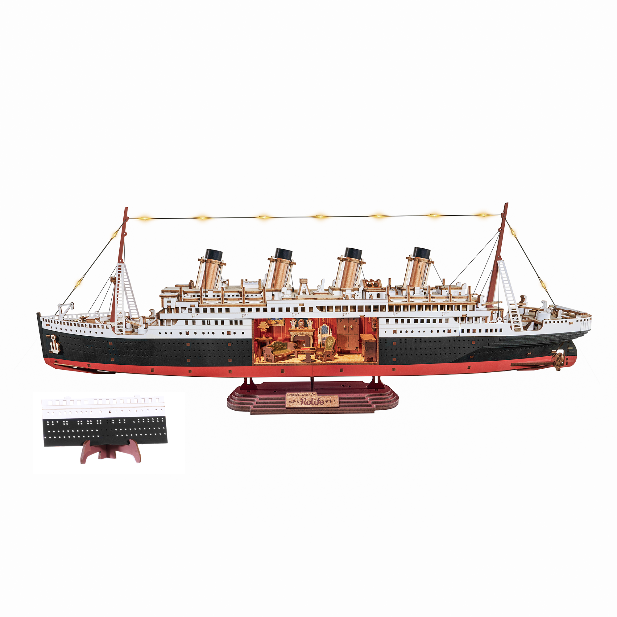 Assembled laser cut wooden model of a white and black cruise ship with cut away to show the interior. 