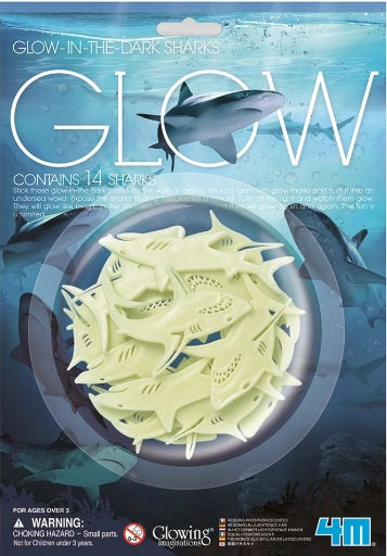 Glow-in-the-dark shark toys in packaging with shark illustrations and text.