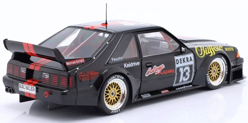1/18 scale model of a 1994 Ford Mustang 5.0 DTM black in color with red stripes and racing graphics.