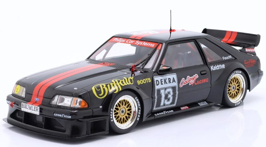 1/18 scale model of a 1994 Ford Mustang 5.0 DTM black in color with red stripes and racing graphics.