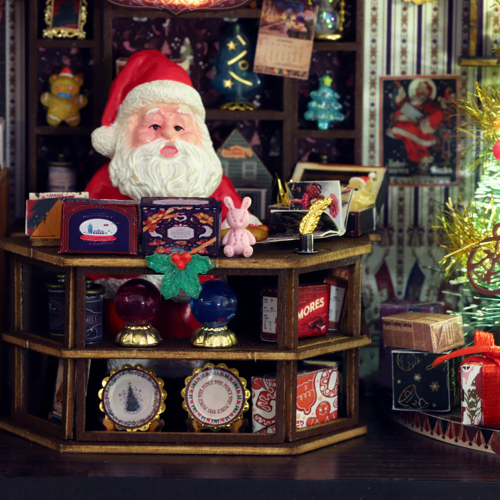 Close up  of Christmas Wonerland kit showing Santa behind a counter full of treasures.
