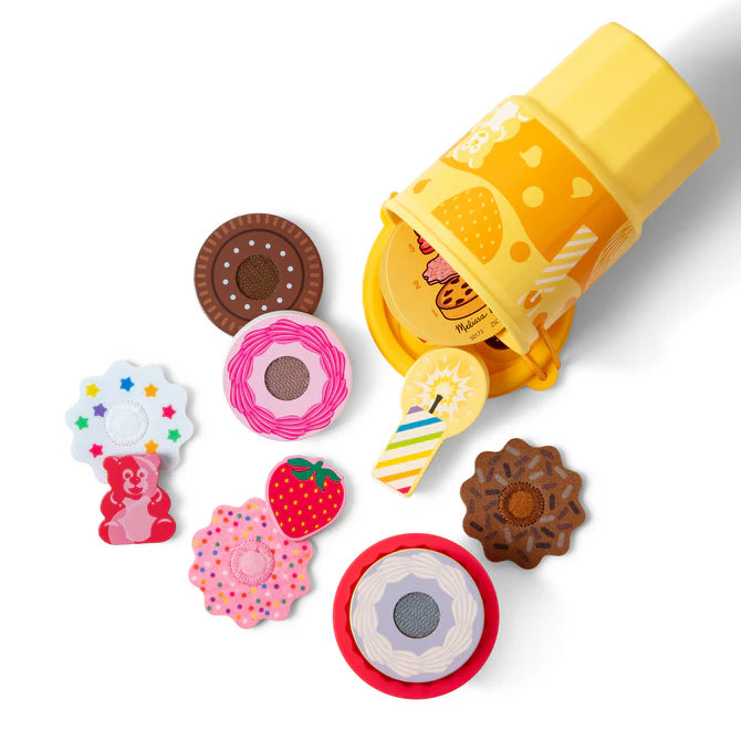Pretend play cake and cookies pieces spilling out of a yellow cup.