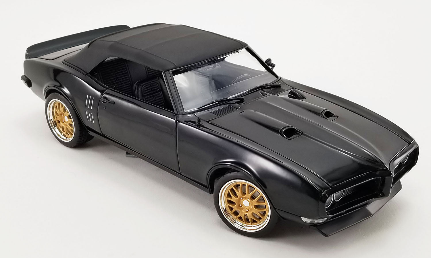 1/18 scale diecast model car of 1969 Pontiac Firebird in black with a closed convertible roof.