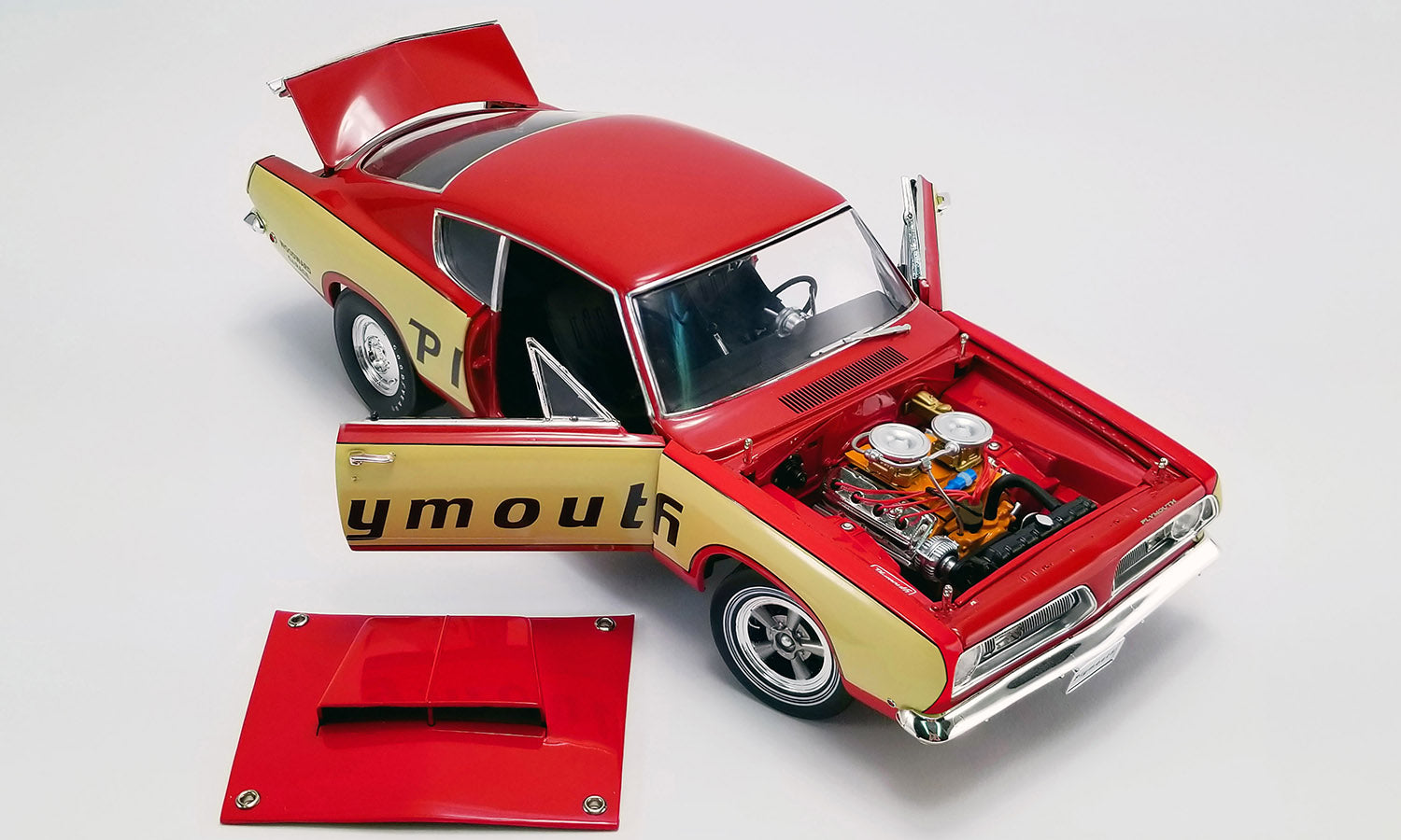 Model car with open hood displaying engine details on a white background
