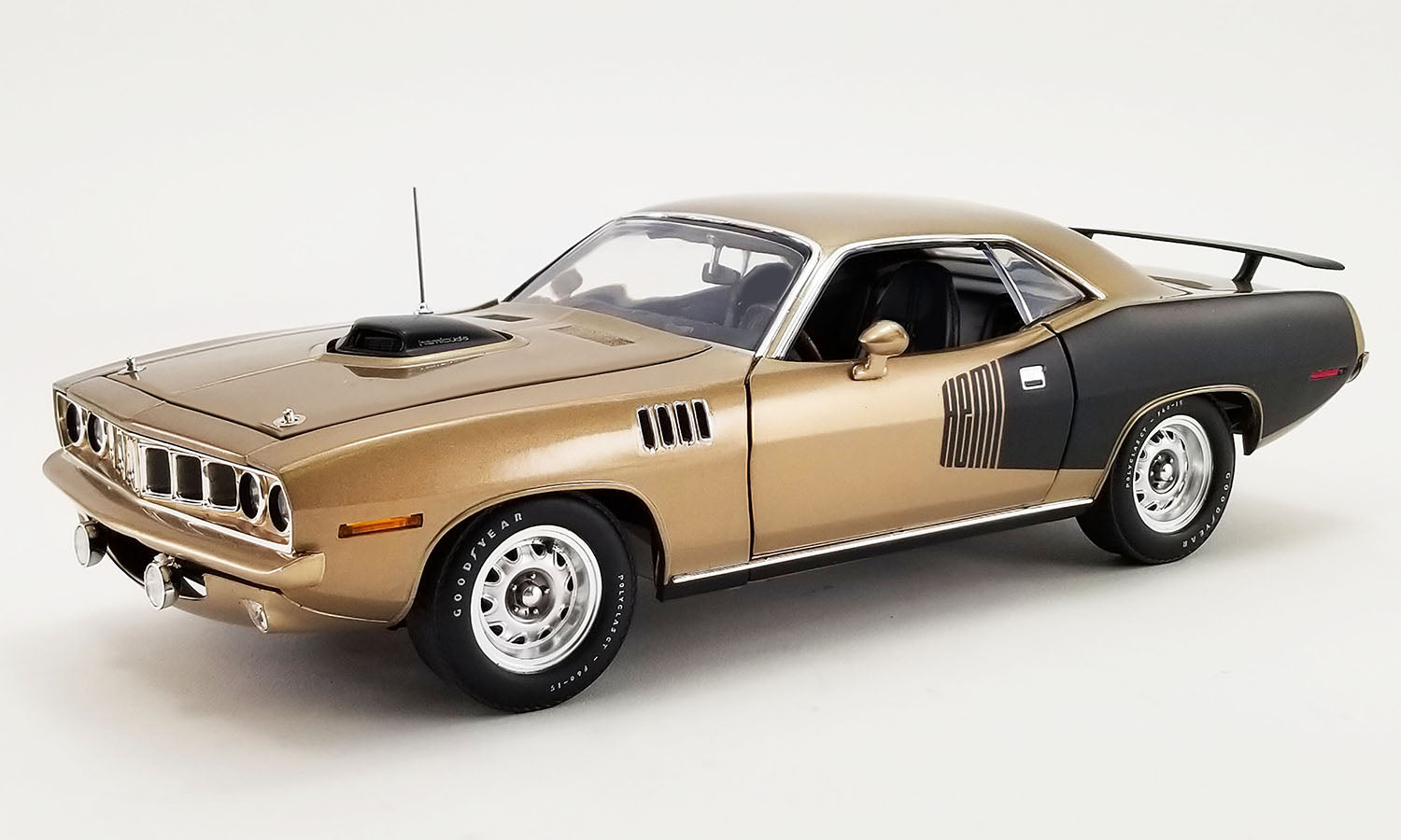 1/18 Scale model car of a 1970 Hemi Cuda in gold with black "HEMI" Billboard.