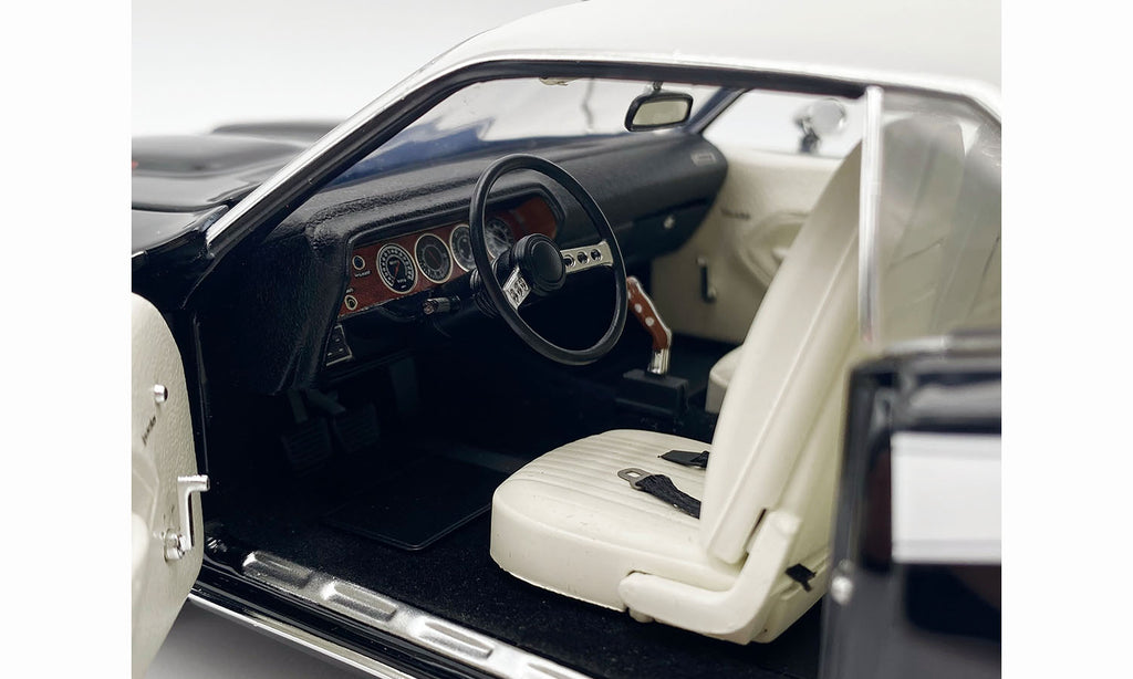 Interior view of 1/18 scale model car in black with white seats.