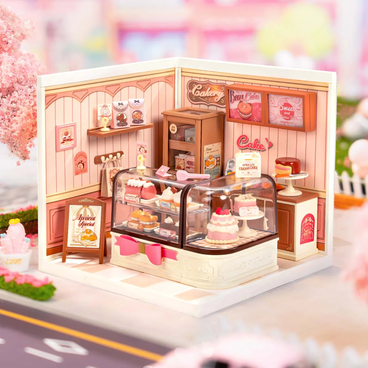 Miniature model of a bakery with various pastries and decor elements.