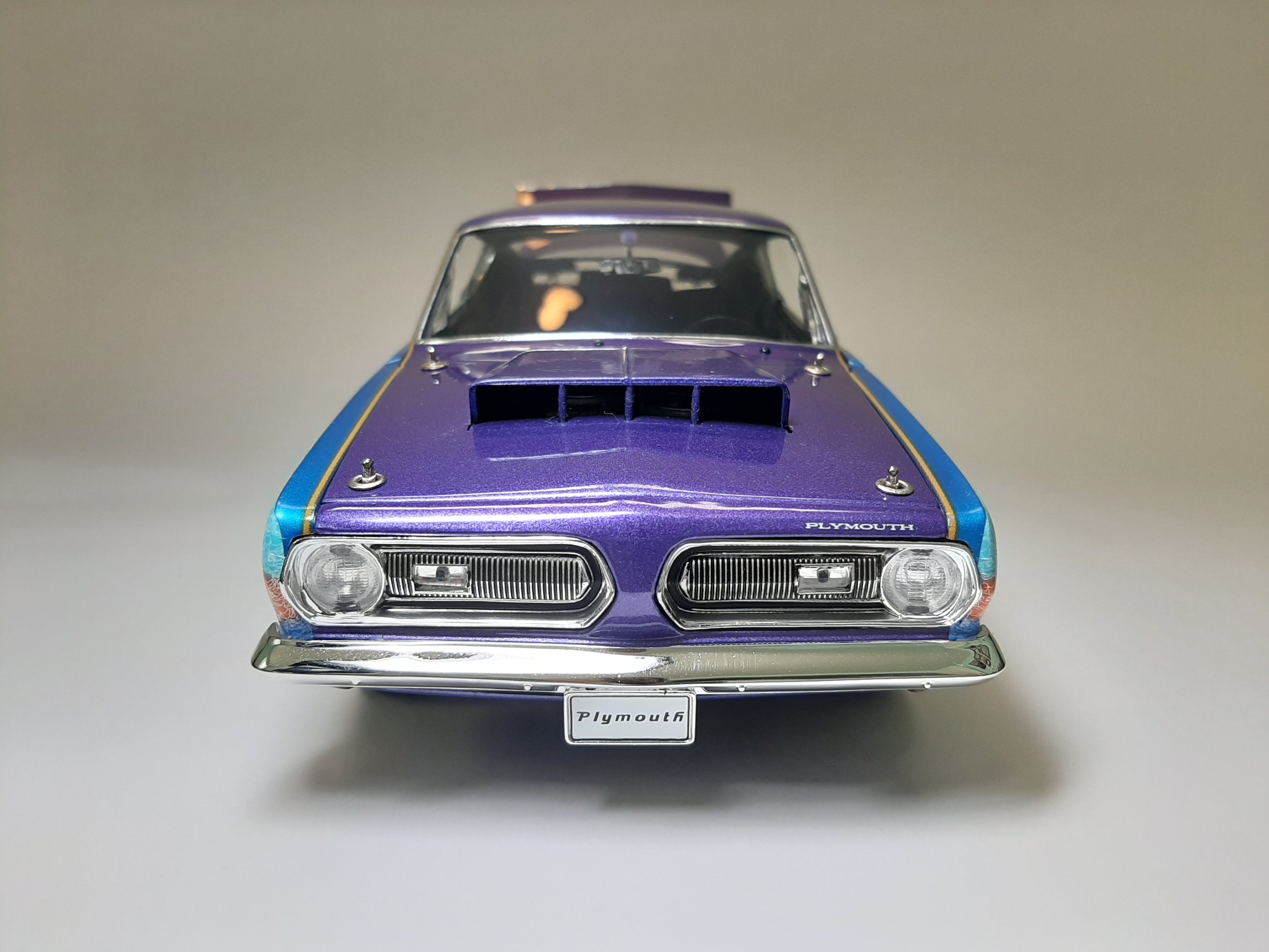 A 1/18 scale diecast model of a 1968 Plymouth Barracuda.
