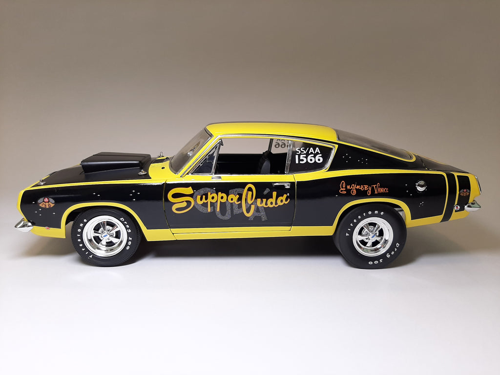A 1/18 scale mode of 1968 Barracuda that is black and yellow with "Suppa Cuda" on the side