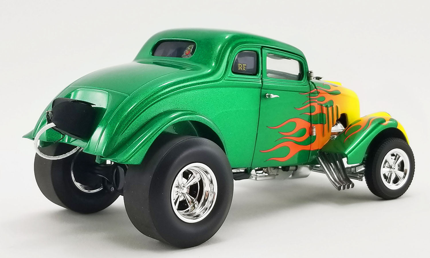 Diecast model car of 1933 Gasser painted green with flames.