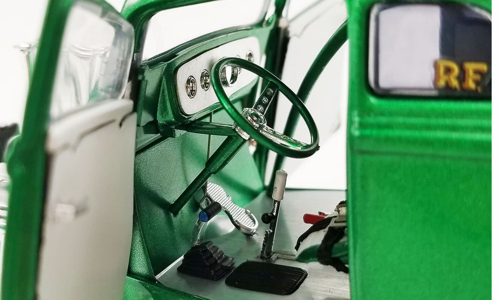 Close up of the interior around the steering wheel of a diecast model car.