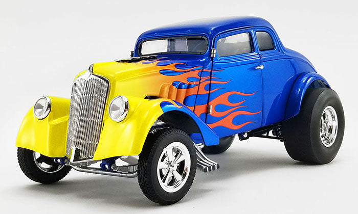 Diecast model car of a 1933 Willys Gasser in blue with yellow to red flames starting at the front  and ending on the doors.