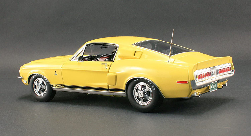 A 1/18 scale model of a yellow 1968 Ford Shelby GT350 Coupe.