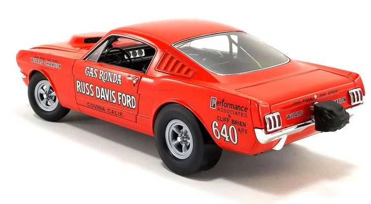 Rearview of 1/18 scale model of a 1965 Ford Mustang GT in red with "Gas Ronda" and other words painted on the sides.
