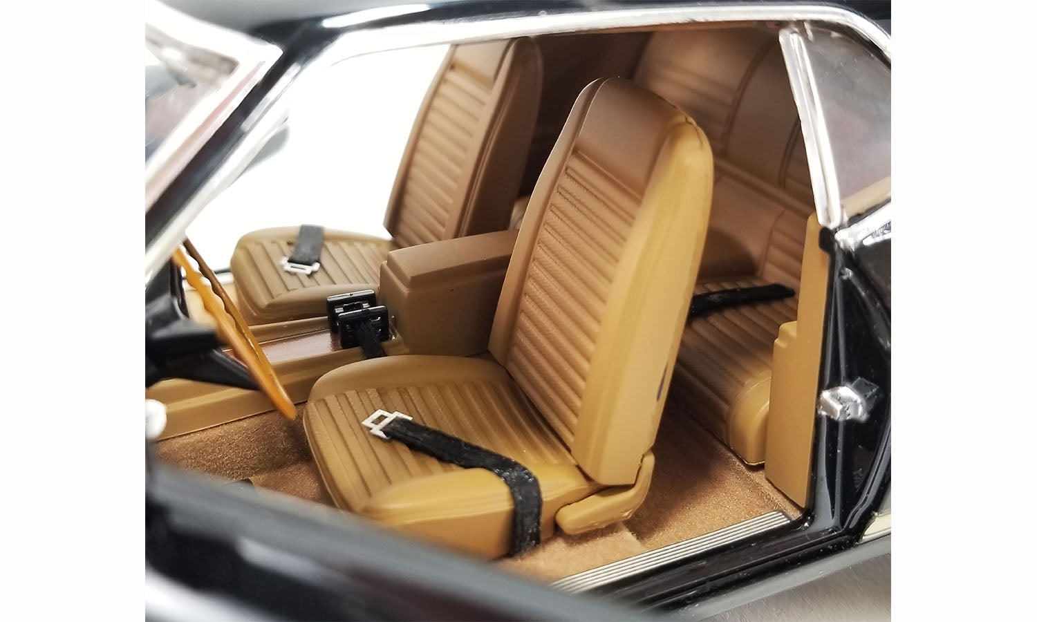 Interior view of the seats in a scale model of a 1969 Mustang.
