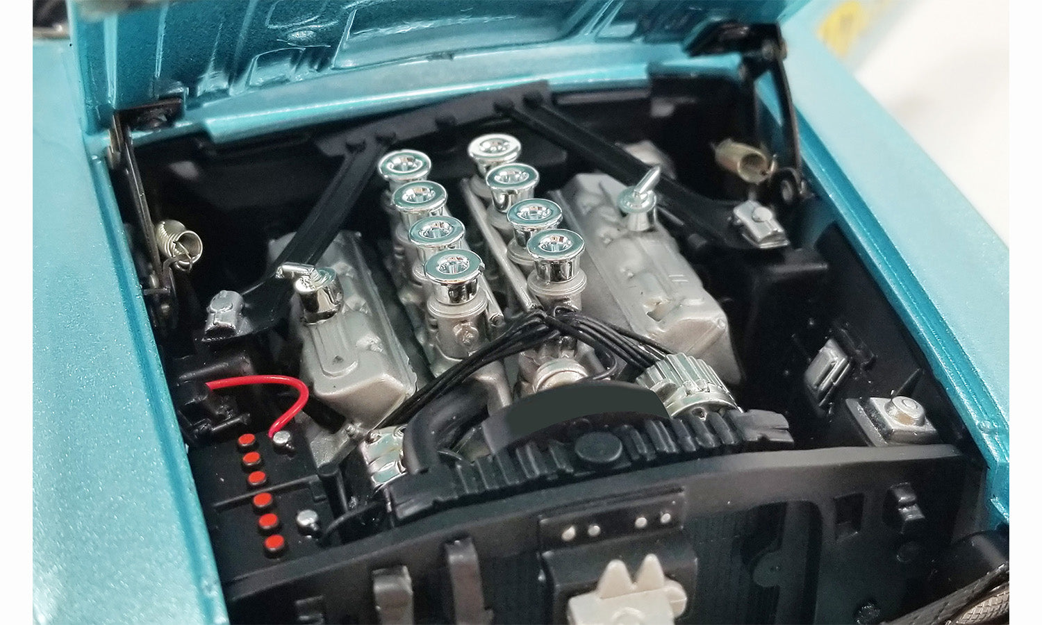 Close up the engine in a diecast model car.