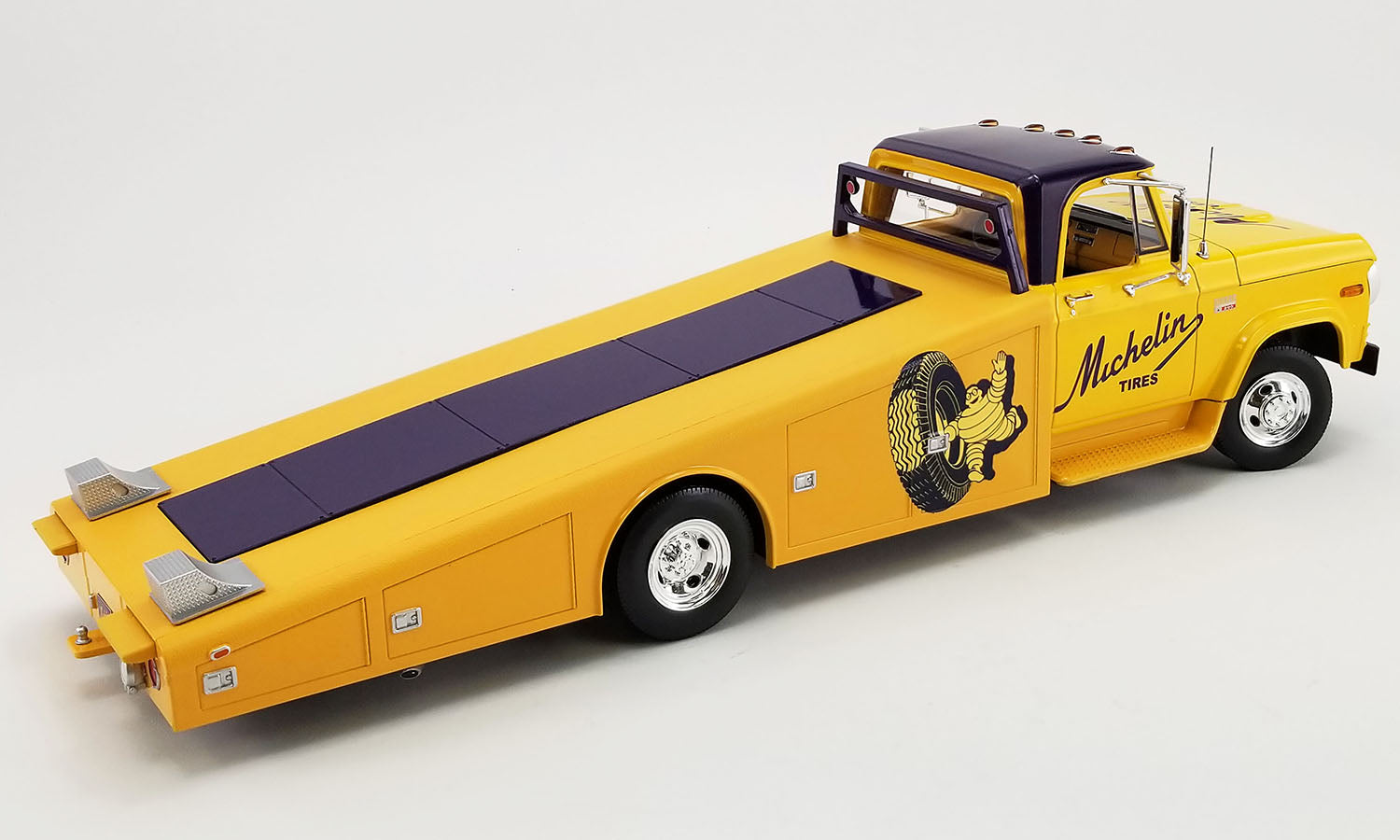 1/18 scale diecast model of 1970 Dodge D-300 Ramp Truck in yellow with Michelin Tire graphics.