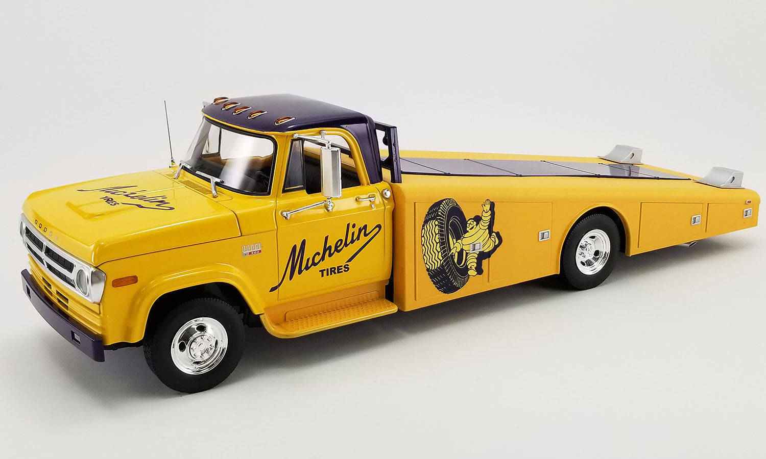 1/18 scale diecast model of 1970 Dodge D-300 Ramp Truck in yellow with Michelin Tire graphics.