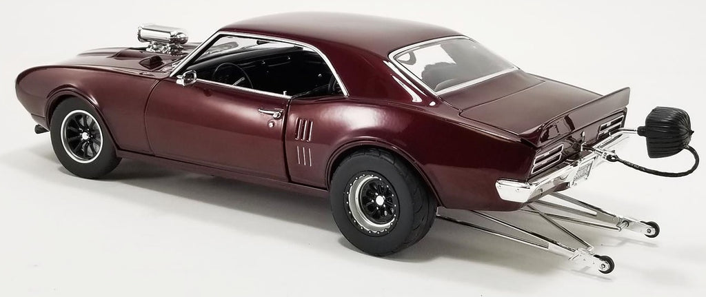 A 1/18 scale model of a 1968 Pontiac Firebird Drag Outlaws in metallic maroon color.