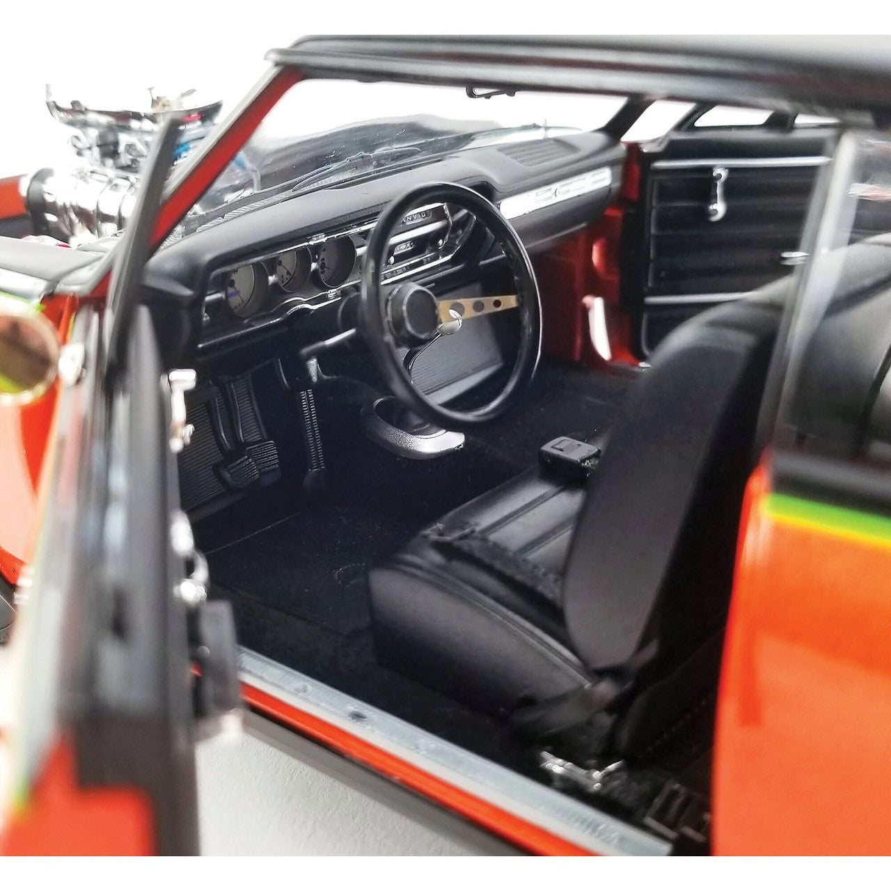 Interior of a 1/18 scale model of a 1965 Chevy Chevelle SS Drag Outlaw in orange and black.