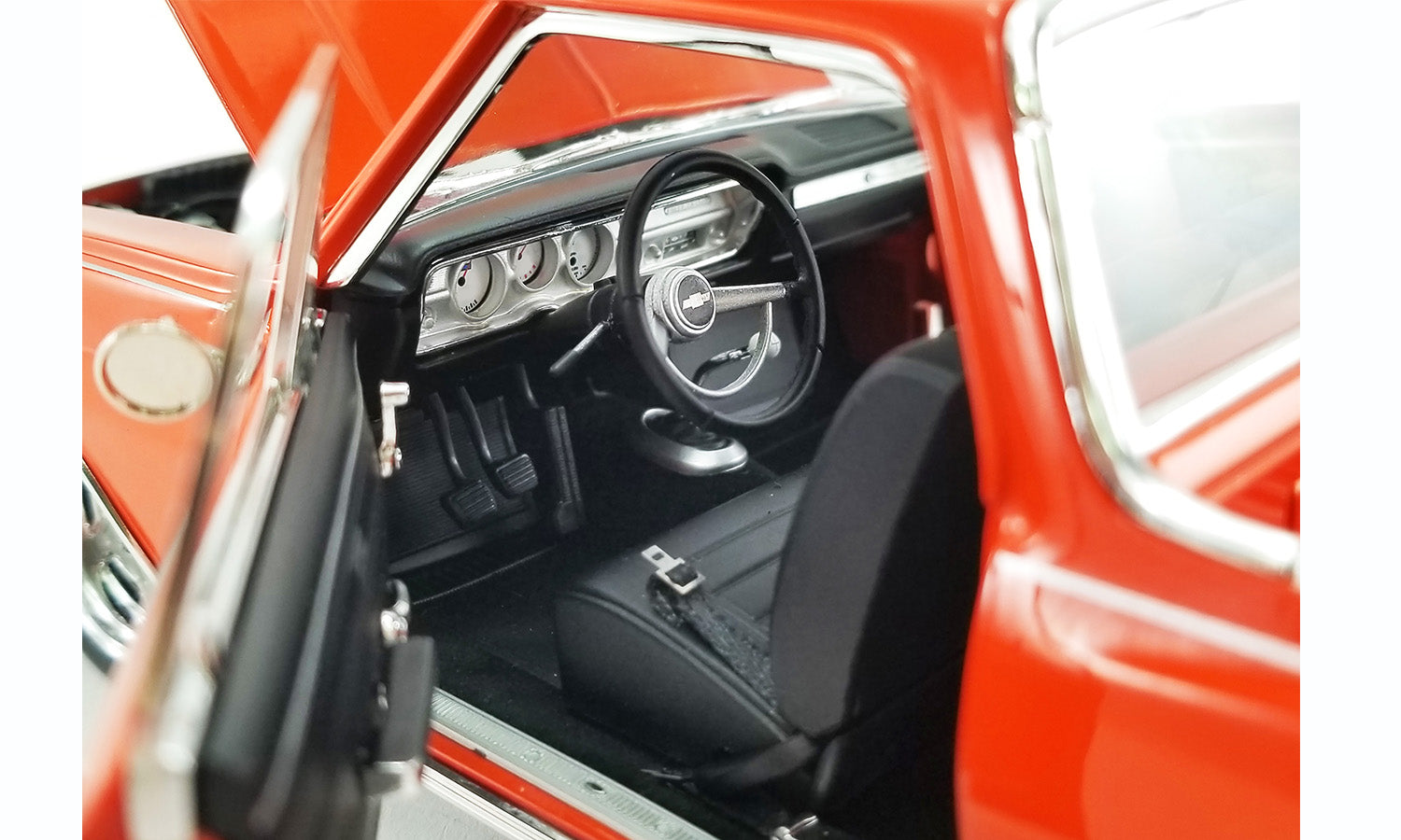 Close up of the interior on a 1/18 scale model of a 1965 Chevrolet El Camino Custom in orange.