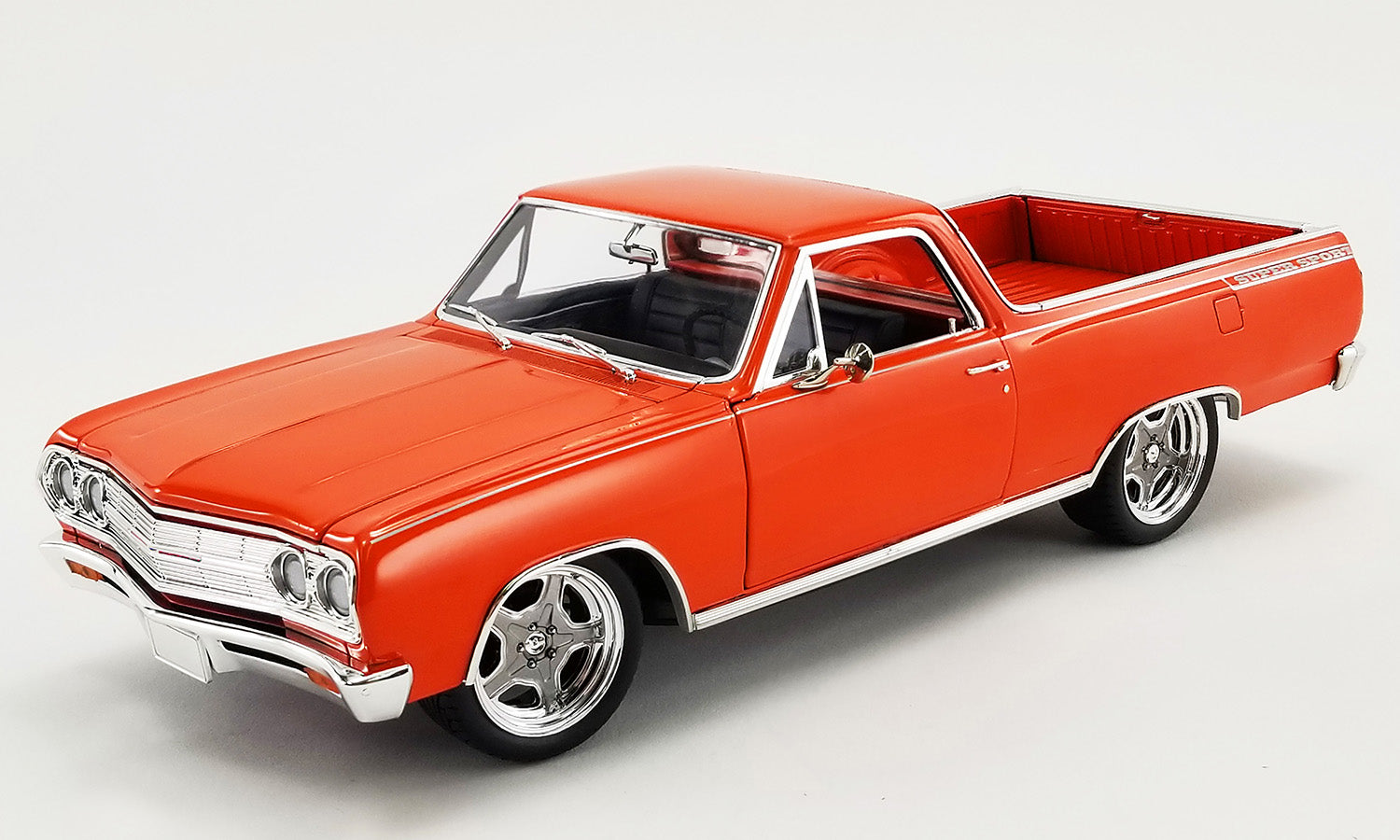1/18 scale model of a 1965 Chevrolet El Camino Custom in orange.