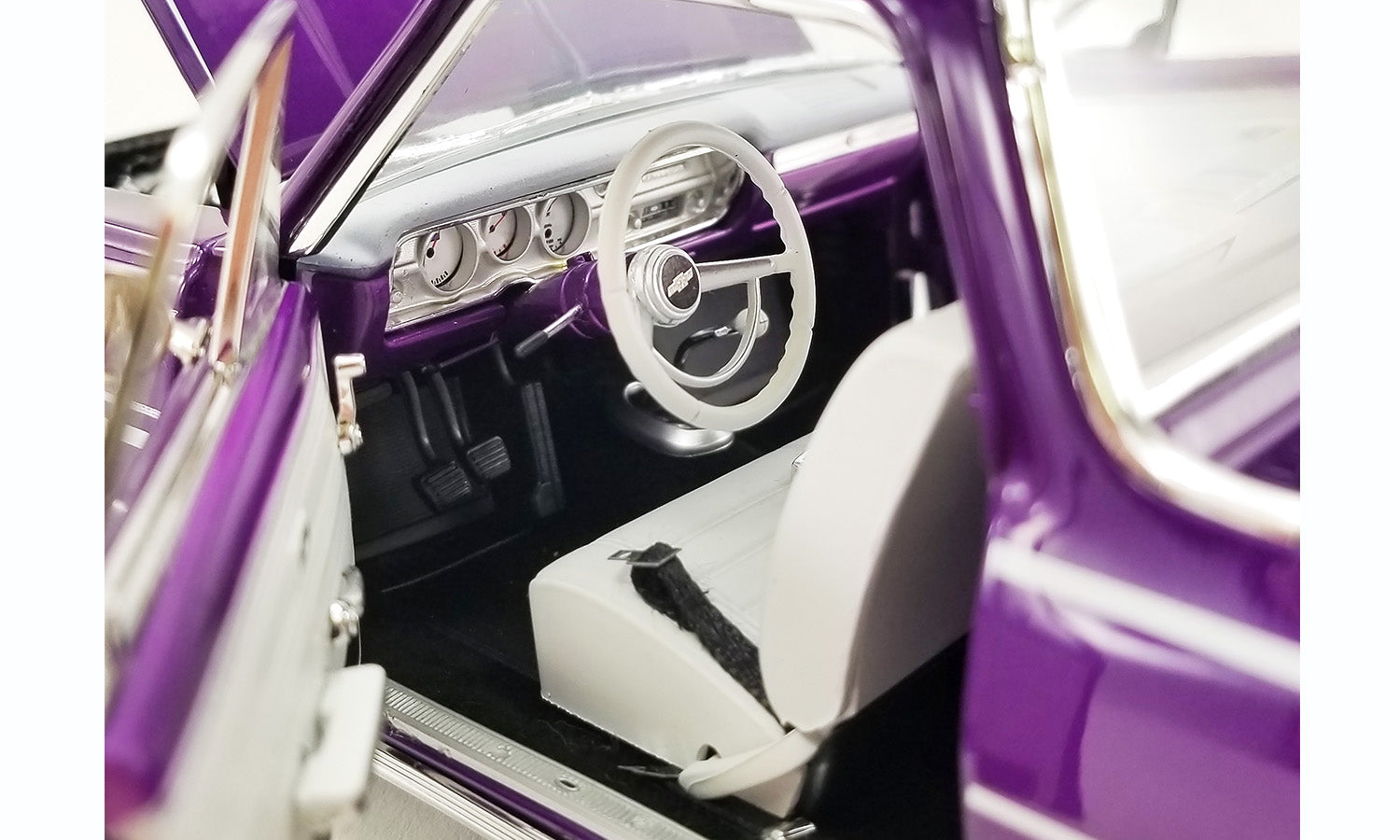 Close up of the interior in a 1/18 scale diecast model car of a purple Chevrolet El Camino.